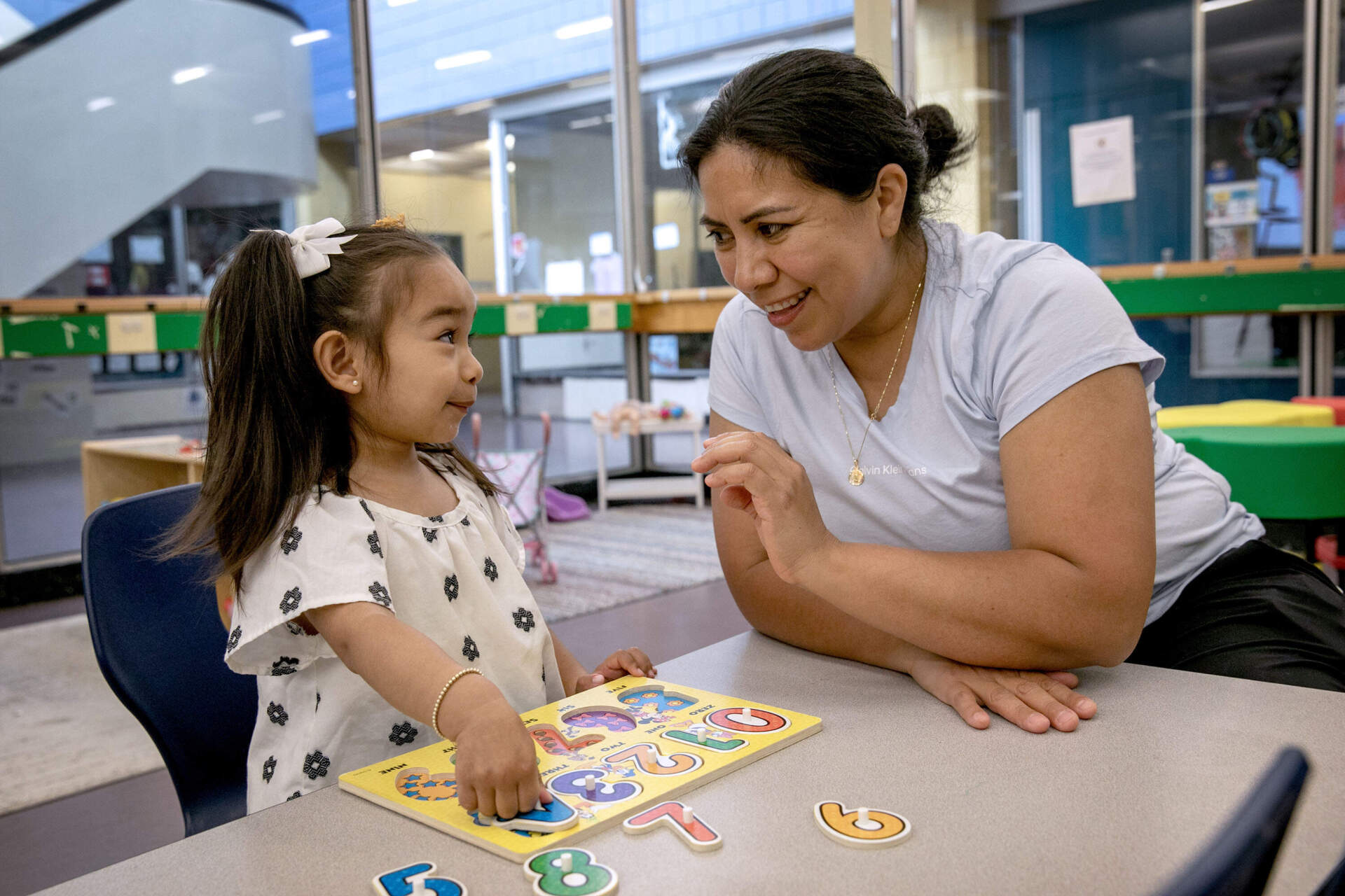 Volunteer parents and family members lead children through activities at a parent-child play group at the Mario Umana Academy in East Boston. (Robin Lubbock/WBUR)