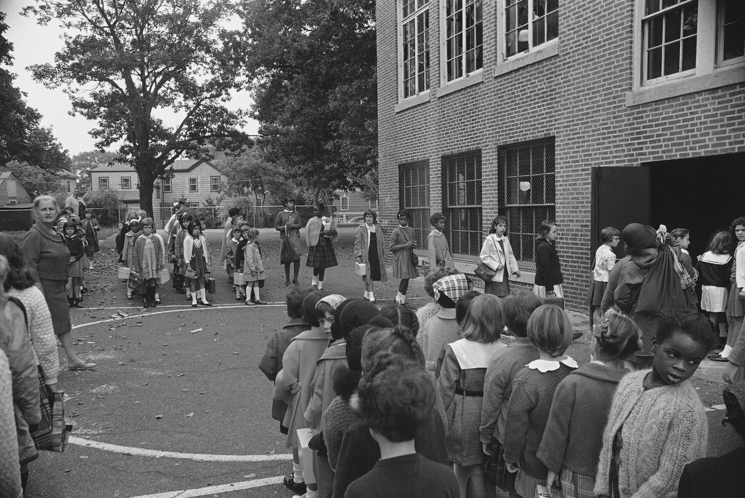 African American girls join whites in entering Edward P. Tileston School, Babson Street in Mattapan Square section of Boston on Sept. 20, 1965. Several hundred African America children from crowded sections of Boston are being bussed to schools in outlying areas under a volunteer plan called